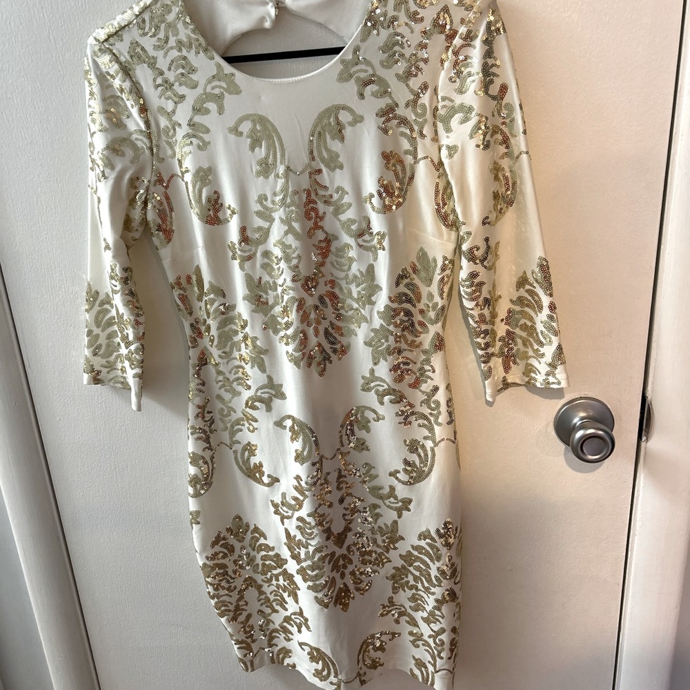 White and gold sequin cock tail dress, half sleeve, open back.
